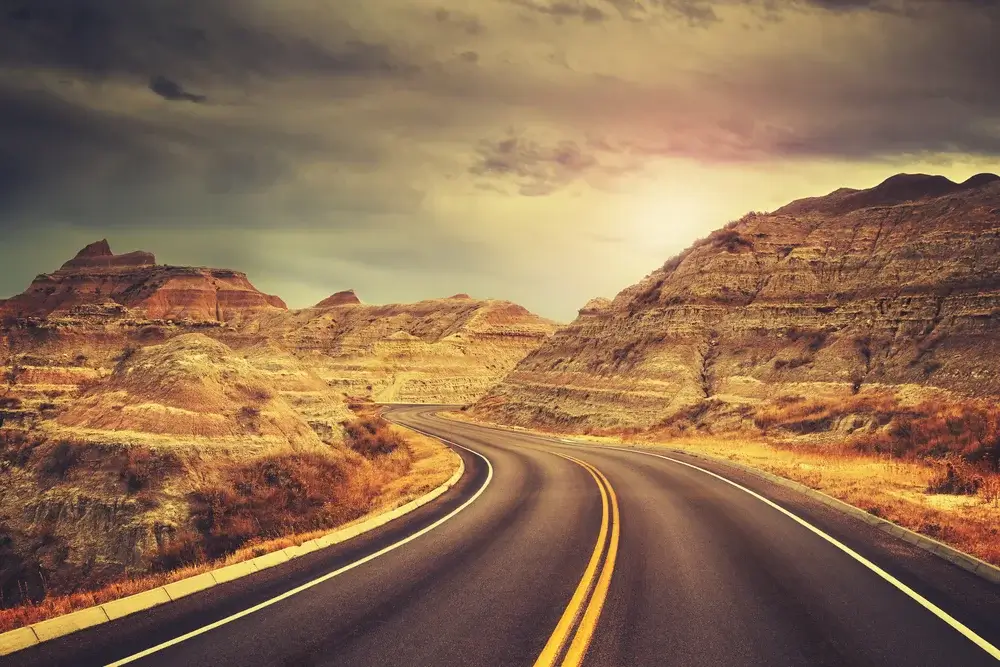 Badlands National Park, South Dakota. Scenic road at sunset. Join The Team