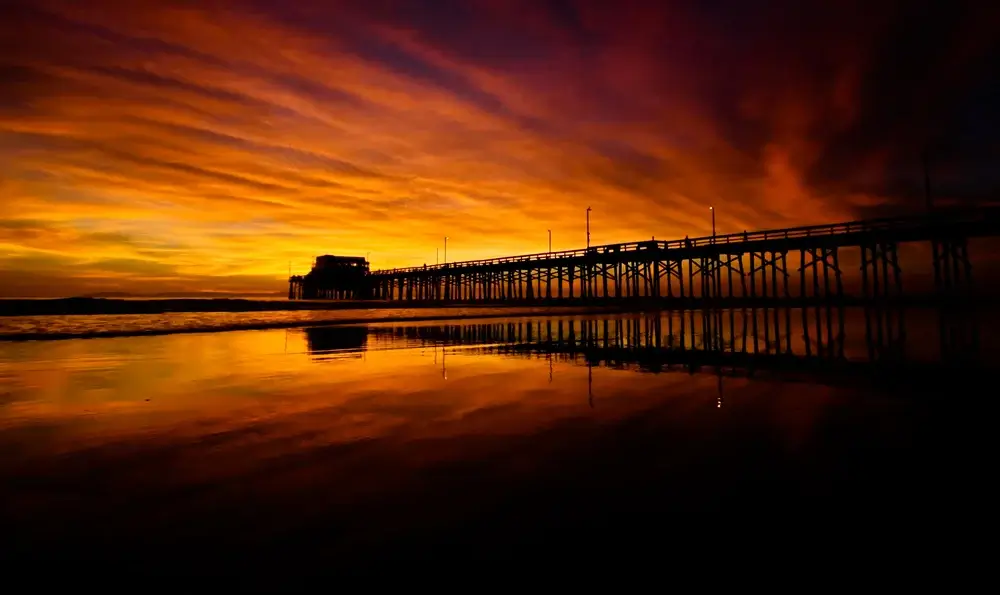 Sunsets over the pier in Orange County, California, USA