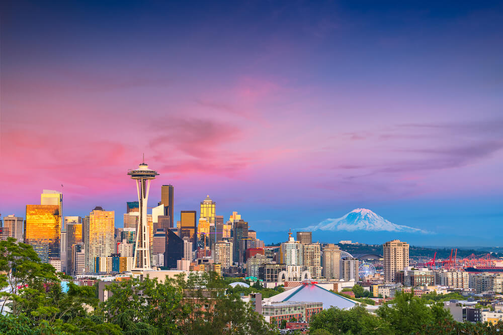 Seattle, Washington, USA, downtown skyline at night with Mt. Rainier.