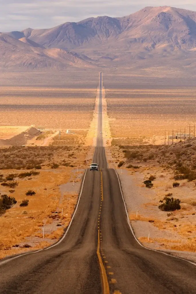 Long desert highway leading into Death Valley National Park